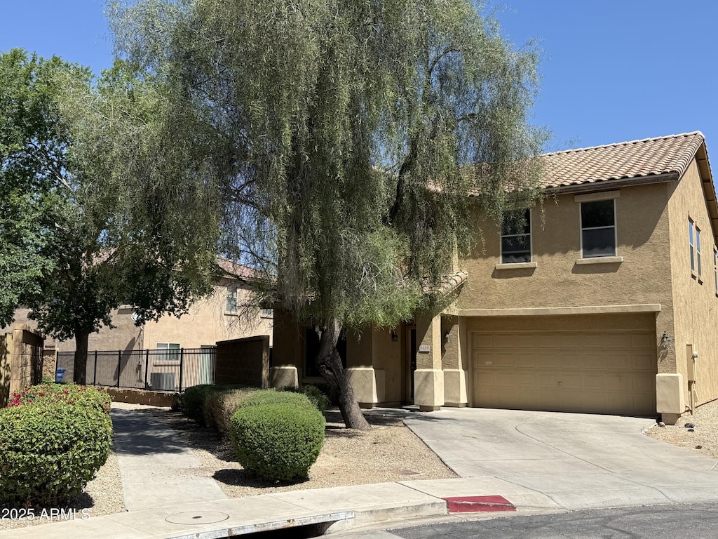 9456 W Jamestown Rd, Phoenix, AZ 85037 - view of front of property featuring stucco siding, driveway, an attached garage, and a tiled roof