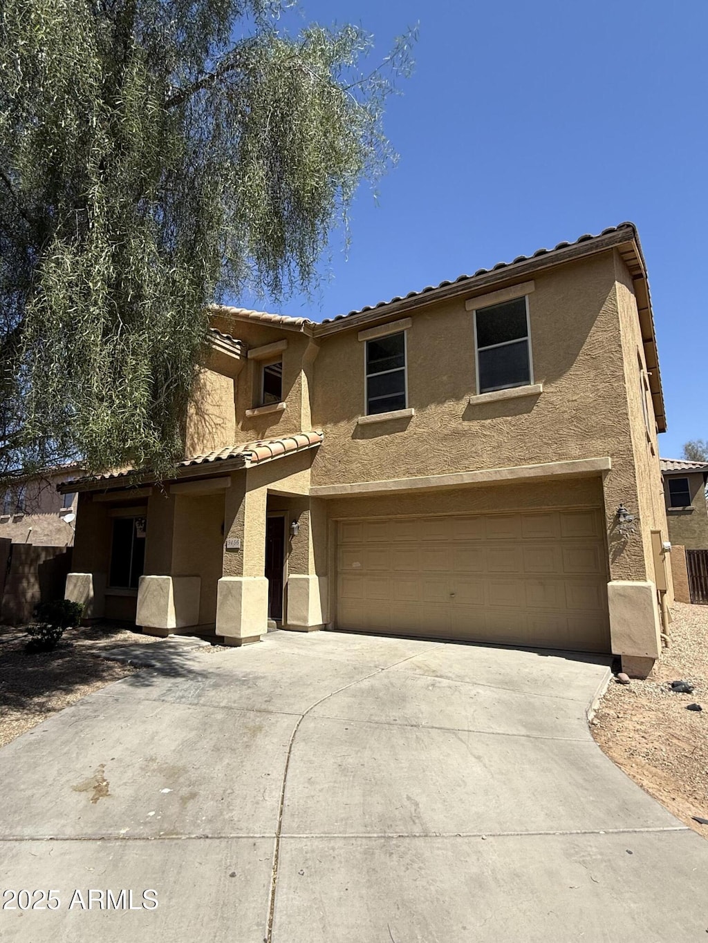 9456 W Jamestown Rd, Phoenix, AZ 85037 - view of front facade with driveway, a garage, and stucco siding