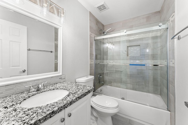 bathroom with visible vents, enclosed tub / shower combo, toilet, and vanity