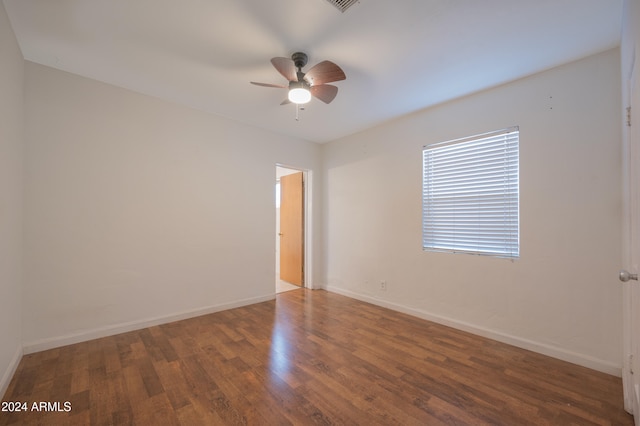 spare room featuring ceiling fan and dark hardwood / wood-style floors