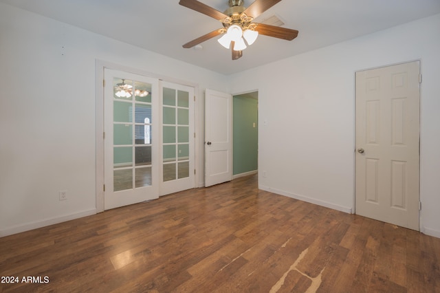 spare room featuring ceiling fan, dark wood-type flooring, and french doors