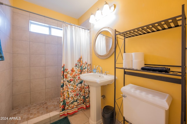 bathroom with toilet, a shower with shower curtain, tile patterned flooring, and sink