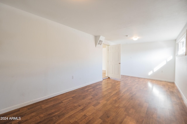 empty room featuring dark hardwood / wood-style flooring