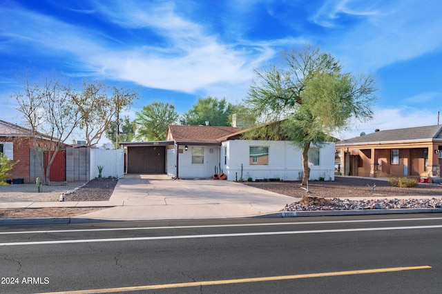 ranch-style house featuring a carport