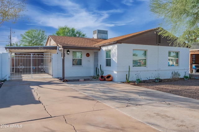 ranch-style house featuring a carport