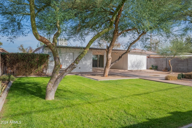 back of house with a lawn