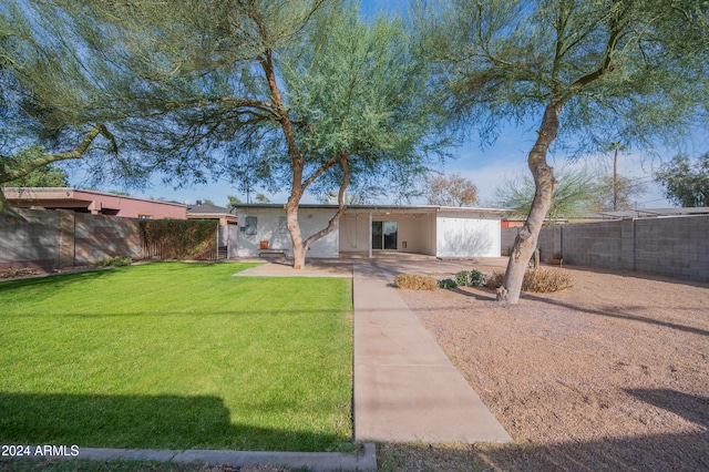 view of front of house featuring a front lawn and a patio