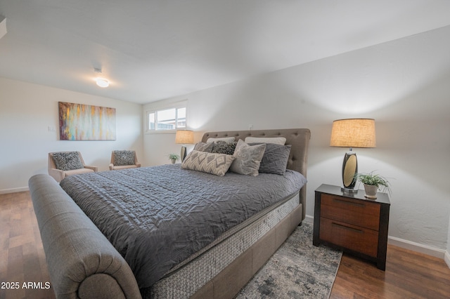 bedroom with dark hardwood / wood-style floors