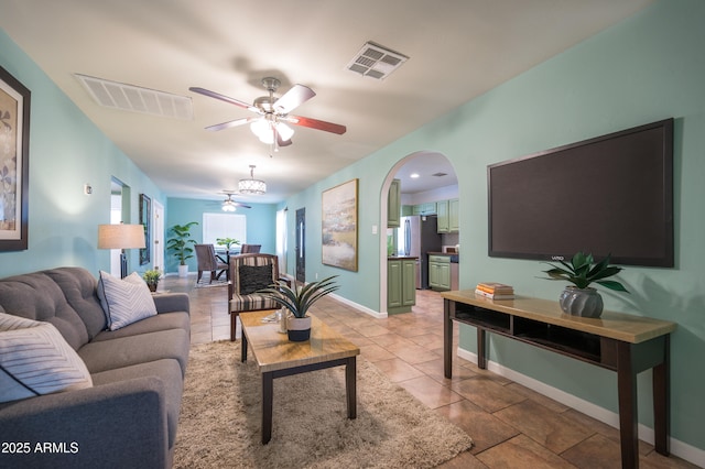 living room featuring ceiling fan and light tile patterned floors