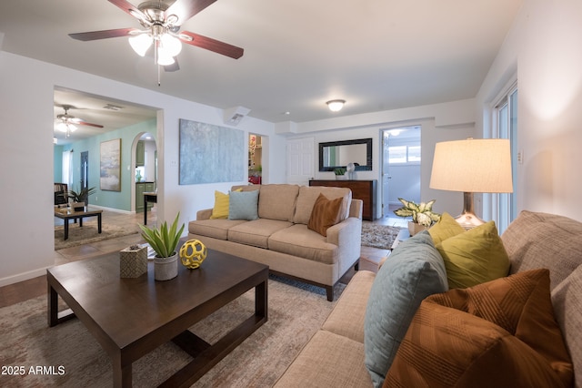 tiled living room featuring ceiling fan