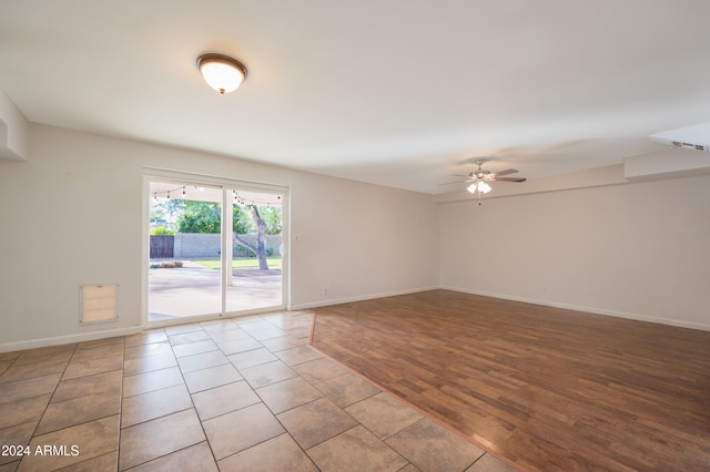 spare room featuring light wood-type flooring and ceiling fan