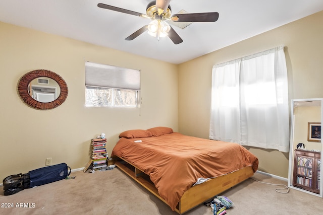 bedroom with ceiling fan and light carpet