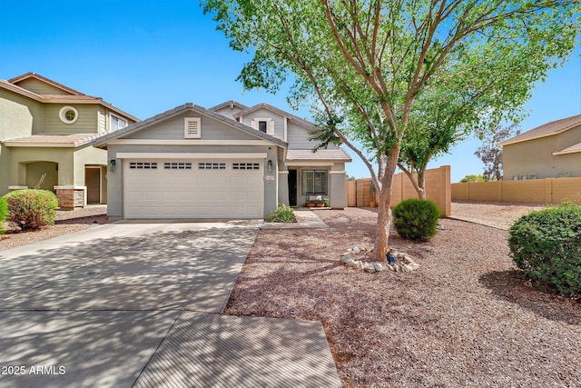 view of front of property with a garage, concrete driveway, and fence