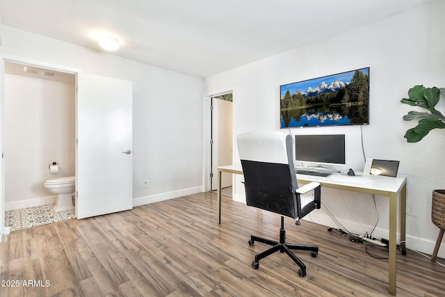 office with wood finished floors, visible vents, and baseboards