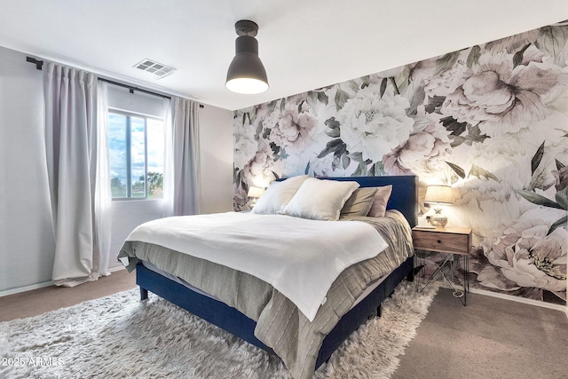 carpeted bedroom featuring visible vents and baseboards