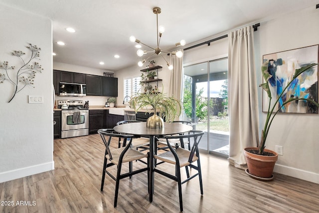 dining room with light wood-type flooring, plenty of natural light, and baseboards