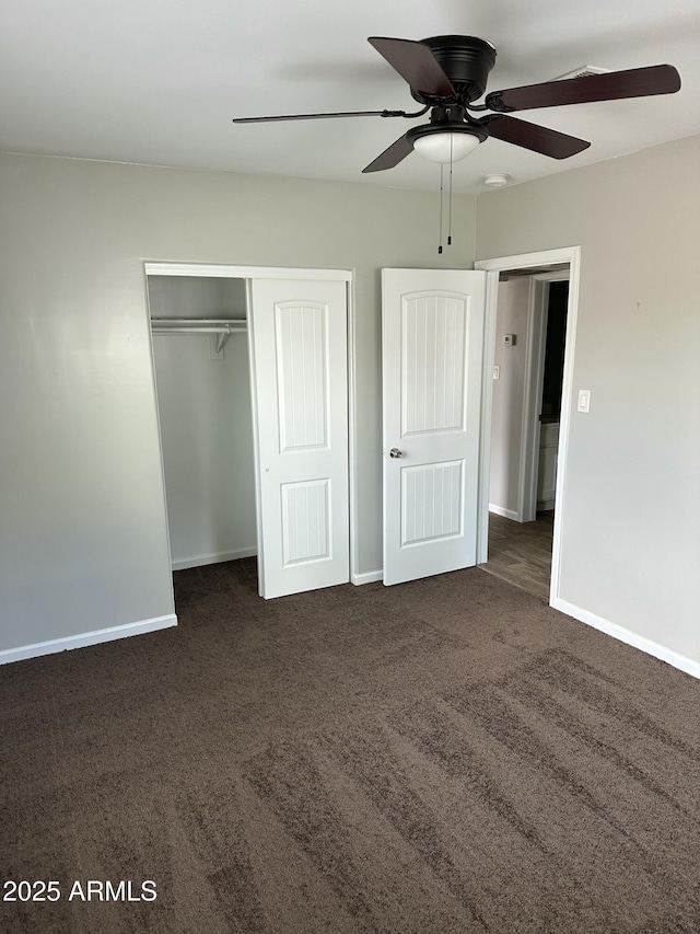 unfurnished bedroom with a closet, carpet flooring, ceiling fan, and baseboards