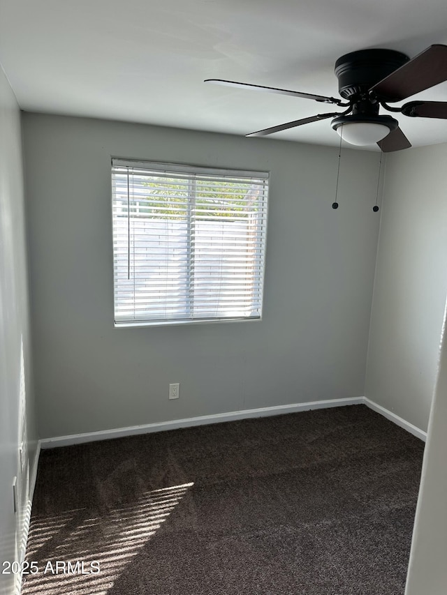 empty room featuring carpet flooring, a ceiling fan, and baseboards