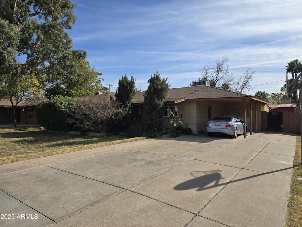 exterior space with a carport and a front yard