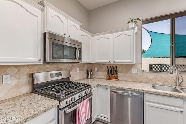 557 S Lemon Ct, Gilbert, AZ 85296 - kitchen featuring appliances with stainless steel finishes, white cabinets, decorative backsplash, and light stone counters