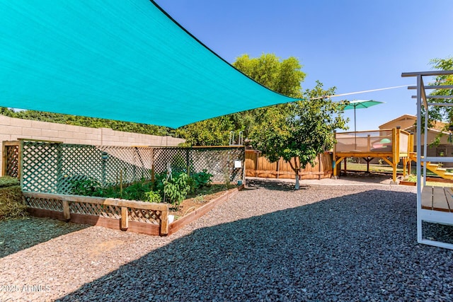 557 S Lemon Ct, Gilbert, AZ 85296 - view of yard featuring a playground and a vegetable garden