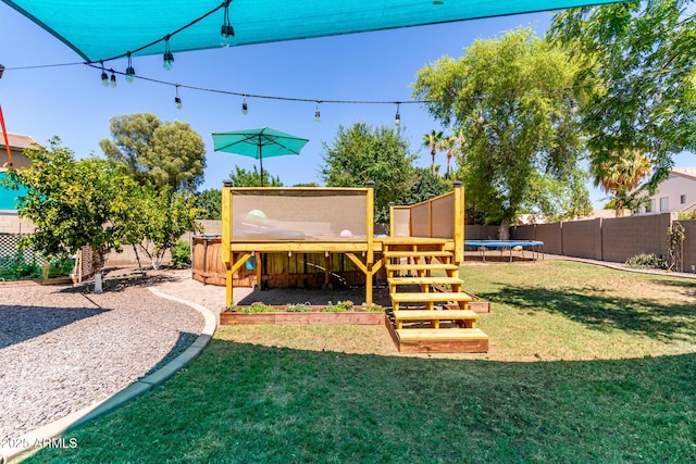 557 S Lemon Ct, Gilbert, AZ 85296 - fenced backyard with a trampoline and a wooden deck