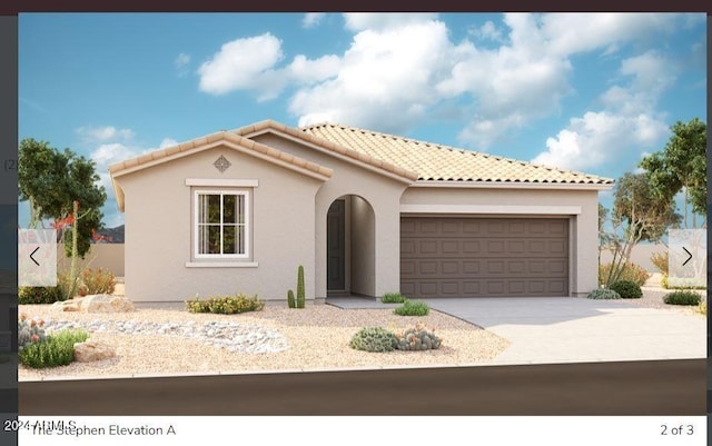 mediterranean / spanish-style house with stucco siding, driveway, a tile roof, and an attached garage