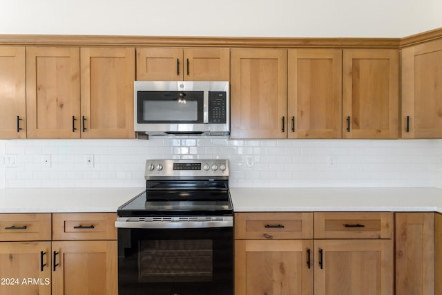 kitchen featuring stainless steel appliances and tasteful backsplash