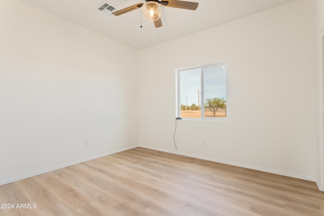 spare room with ceiling fan and light wood-type flooring