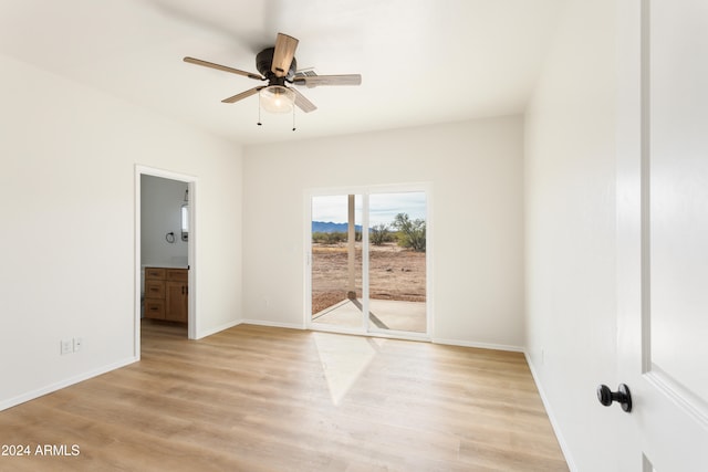 empty room featuring ceiling fan and light hardwood / wood-style flooring