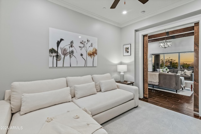 living room featuring ceiling fan with notable chandelier and ornamental molding