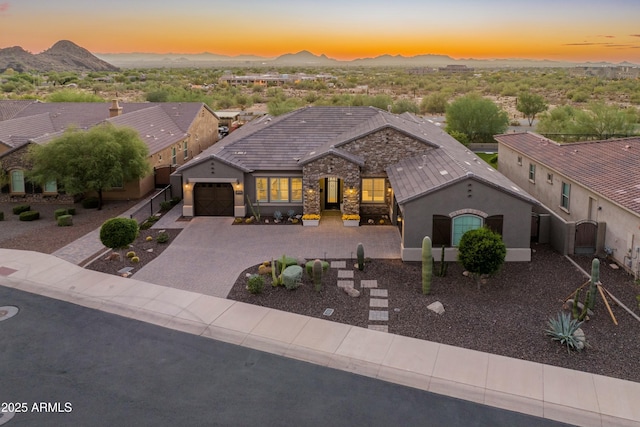 view of front facade with a garage and a mountain view