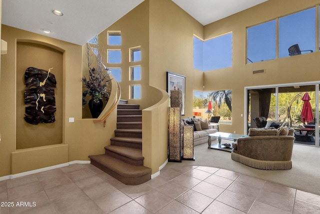 13827 N Mesquite Ln, Fountain Hills, AZ 85268 - stairway featuring baseboards, tile patterned flooring, visible vents, and a towering ceiling