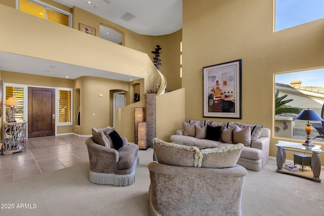 13827 N Mesquite Ln, Fountain Hills, AZ 85268 - tiled living room featuring a high ceiling, baseboards, and carpet floors