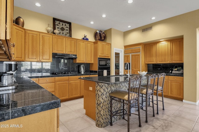 13827 N Mesquite Ln, Fountain Hills, AZ 85268 - kitchen with visible vents, under cabinet range hood, a center island with sink, built in appliances, and a breakfast bar area