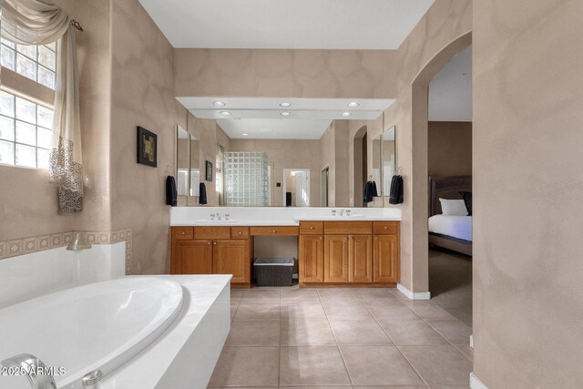 13827 N Mesquite Ln, Fountain Hills, AZ 85268 - ensuite bathroom featuring tile patterned flooring, double vanity, a bath, and a sink