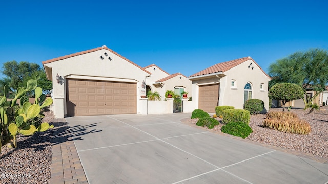 mediterranean / spanish-style house with a garage