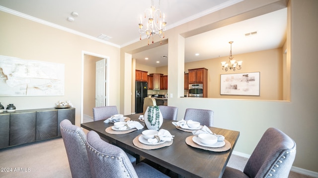 dining room featuring light colored carpet, an inviting chandelier, and ornamental molding