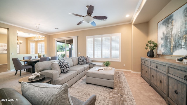 living room with light carpet, ceiling fan with notable chandelier, and ornamental molding