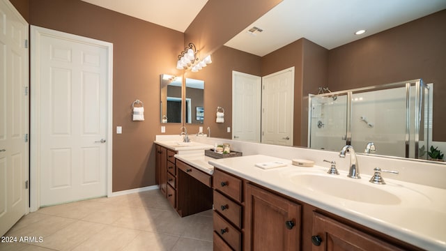 bathroom featuring tile patterned flooring, an enclosed shower, and vanity