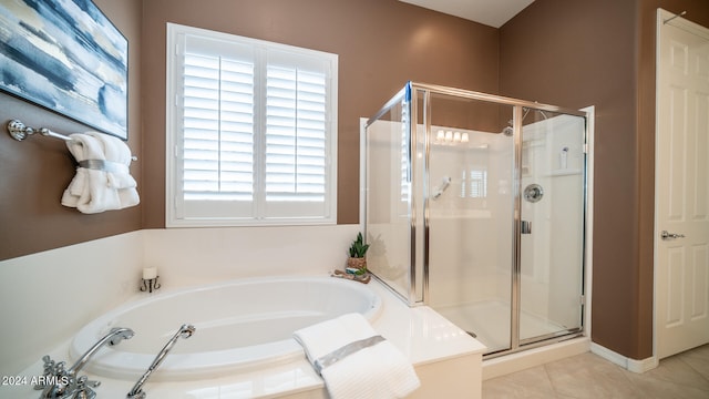 bathroom with shower with separate bathtub and tile patterned floors