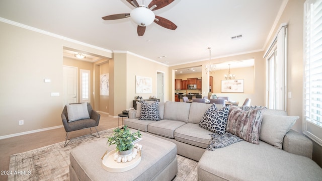 living room with ceiling fan with notable chandelier, light colored carpet, and ornamental molding