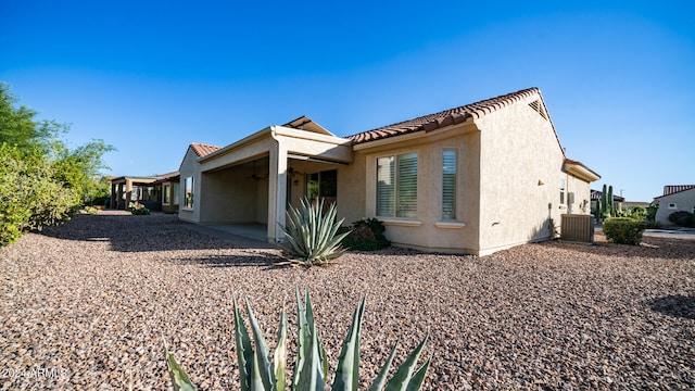 view of side of home featuring a patio and central AC