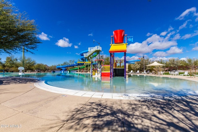 view of jungle gym featuring a community pool