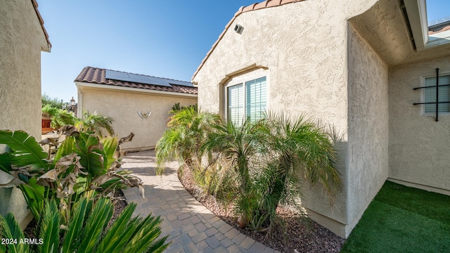 view of exterior entry with a patio area