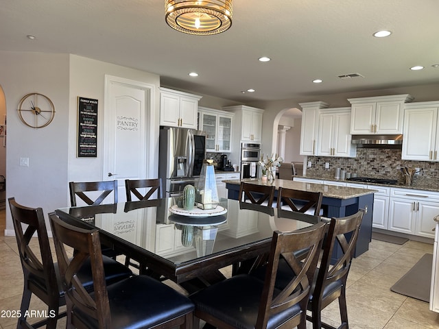 dining room featuring recessed lighting, visible vents, arched walkways, and light tile patterned floors