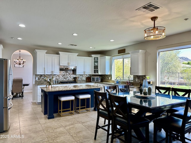 dining area featuring a chandelier, visible vents, recessed lighting, and light tile patterned flooring