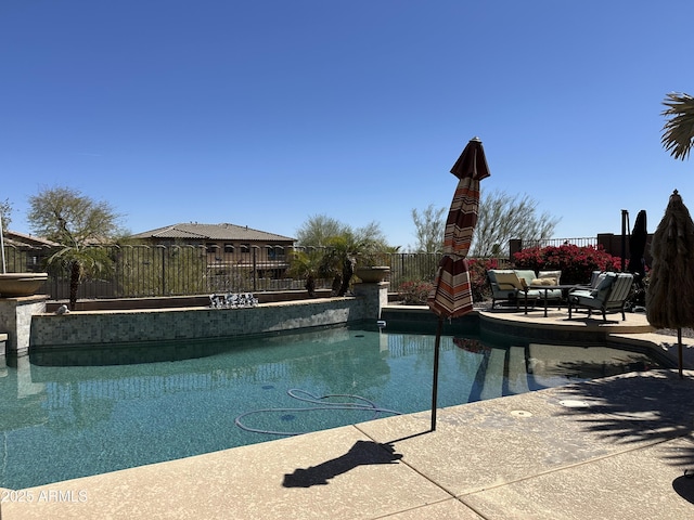 view of swimming pool with a patio area, a fenced in pool, and fence