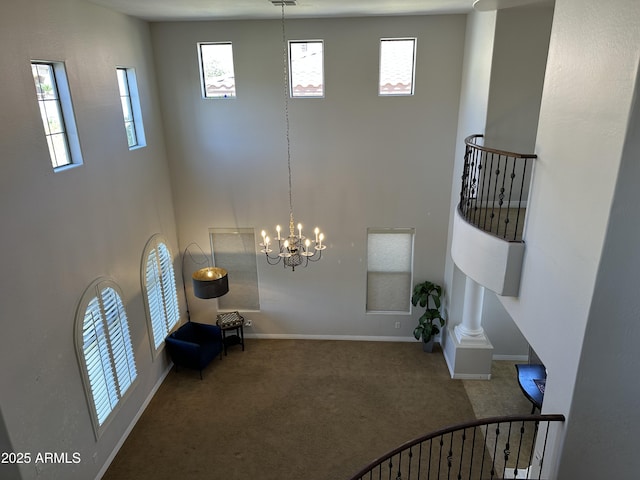 interior space featuring a high ceiling and baseboards