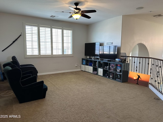 sitting room featuring baseboards, carpet, visible vents, and ceiling fan